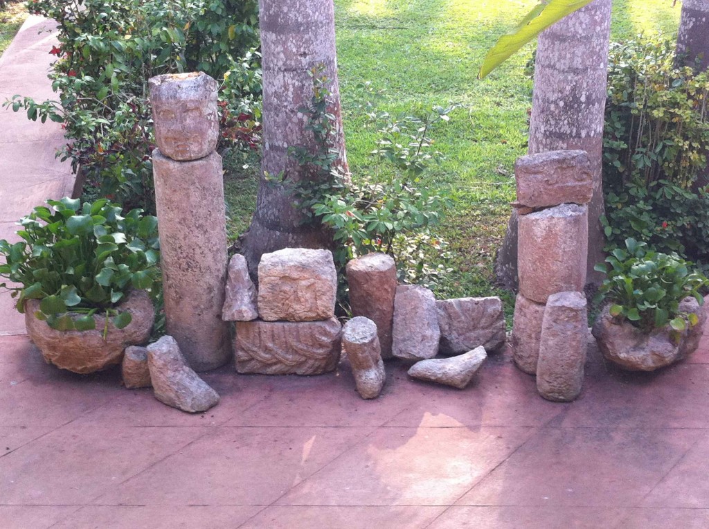 Sculpted stones from Chichén Itzá in the hacienda courtyard